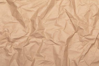 Sheet of brown wrinkled kraft made from recycled paper with texture and details