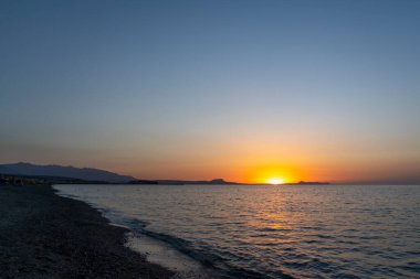 Yunanistan 'ın Girit kentinde güzel bir günbatımında, Rethymno' nun sahil şeridi boyunca uzanan kıyı şeridi