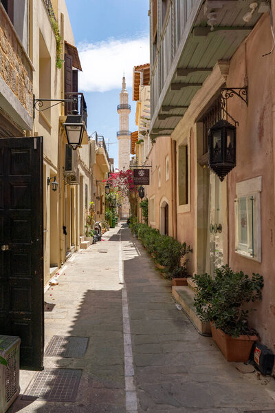 Through this cozy alley you have a view of the minaret of the Neratze Mosque in the old town of Rethymno, Crete, Greece