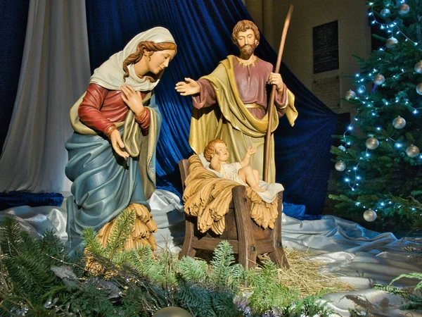 Holy family moment.   Lodz, Poland - December 26, 2022   Figures of the holy family in the nativity scene.