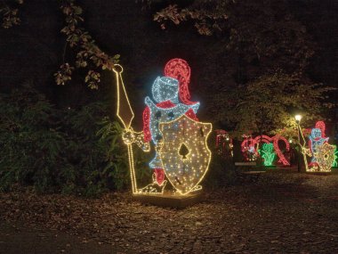 Knights of Light.   Lodz, Poland - October 17, 2022   Spectacularly illuminated decorative figures of knights, one of the attractions of the city park in Lodz.