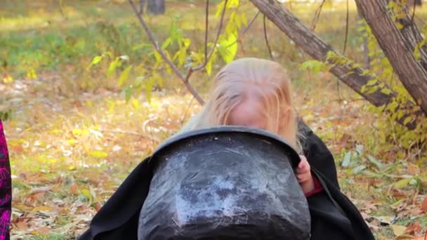 Little Girl Black Robe Hood Playing Toys Sitting Next Cauldron — Vídeo de Stock