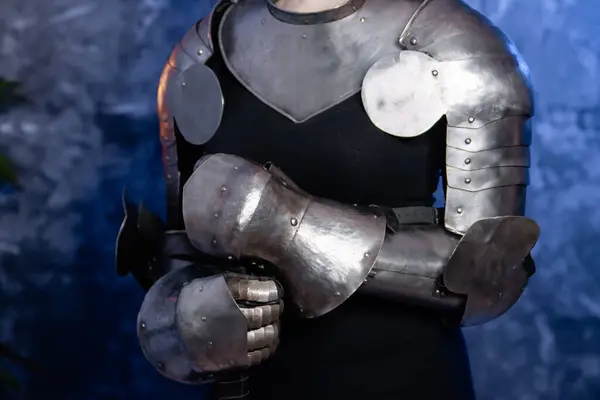 stock image Close-up of armor, knight's steel hands on an abstract background.