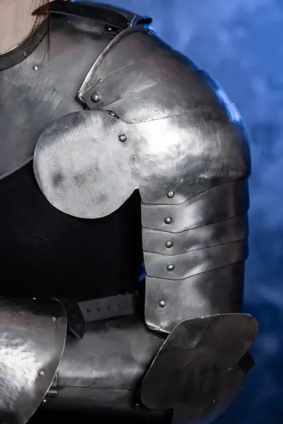 stock image Close-up of armor, knight's steel hands on an abstract background.