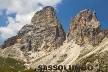 dramatic sky on mountain peaks of Sassolungo in italian alps clipart