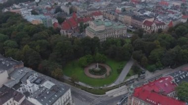 Krakow Eski Kasabası 'nın hava manzarası. Juliusz Sowacki Tiyatrosu ve tarihi merkez Mariacki Kilisesi, Sukiennice ve Wawel 'in insansız hava aracı görüntüleri. Bulutlu bir gün. Yukarı kaldır ve öne doğru uç..