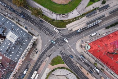 Cracow, Lesser Poland, Poland - September 22 2022: Aerial view of tram rails, tram, bus, intersection Pawia and Lubicz street, Planty and Floryjan Straszewski monument. Top down view cross roads on center Krakow.