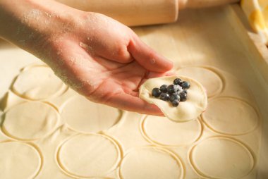 step by step making blueberry dumplings pierogi varenky at home. Process of making traditional summer polish or ukrainian dish with flour and fruits clipart