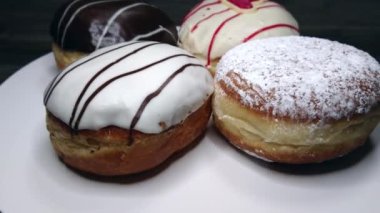 Four delicious sugar, chocolate doughnuts, rotating video
