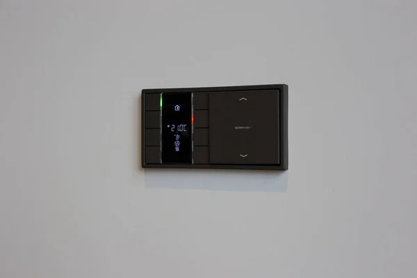 Control panel for smart home. Smart screen with smart home on the wall in the interior.
