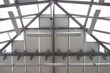 Motorized pleated blinds on the roof windows. Blinds for skylights, beige color. Honeycomb pleated blinds on glass roof.