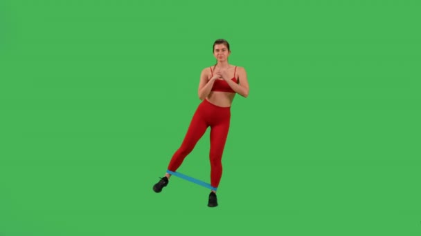 Active Sporty Woman Doing Resistance Band Leg Lifts Dressed Red — Vídeos de Stock