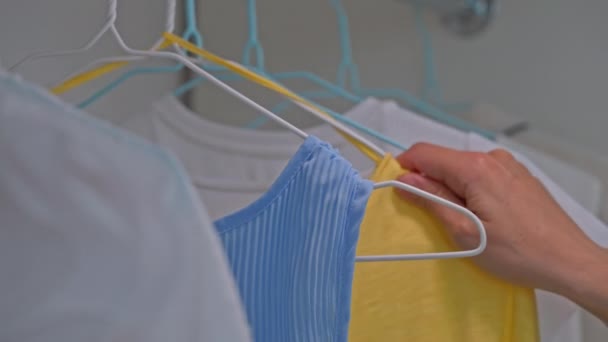 Close Details Woman Holding Hangers Blue Yellow Blouses — Αρχείο Βίντεο