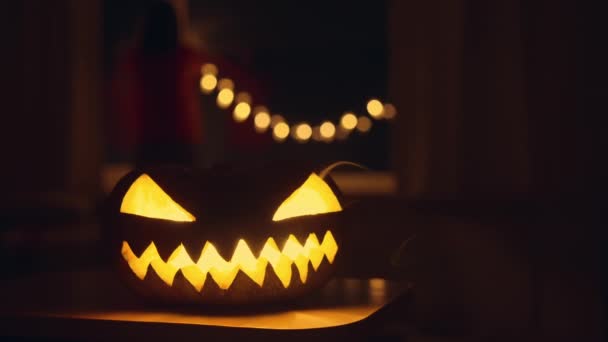 Carved Pumpkin Glowing Eyes Sits Table Emitting Eerie Light Pumpkins Video Clip