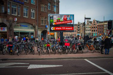 In Amsterdam, a scenic canal winds through the historic city center, lined with gabled houses and houseboats. Tourists navigate the waterways on boats, while locals relax on cafe terraces enjoying clipart