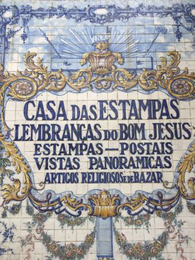 Ceramic tile artwork Braga, Portugal. Portuguese text. Religious souvenirs. Depicts Catholic imagery. Shop signage. clipart