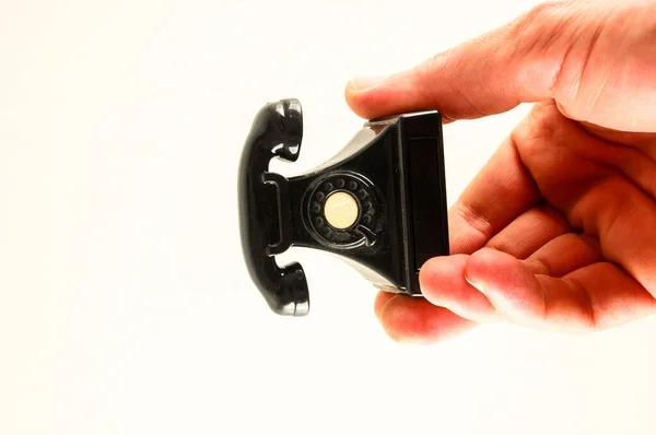Close-up of toy telephone  in hand  on a White Background