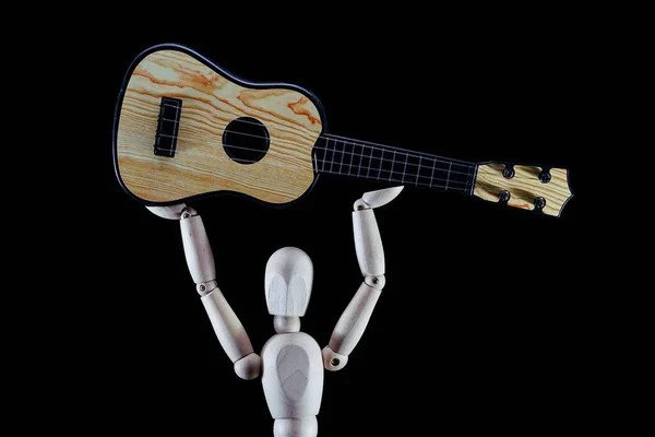 wooden dummy, puppet made of wood, art mannequin with small guitar