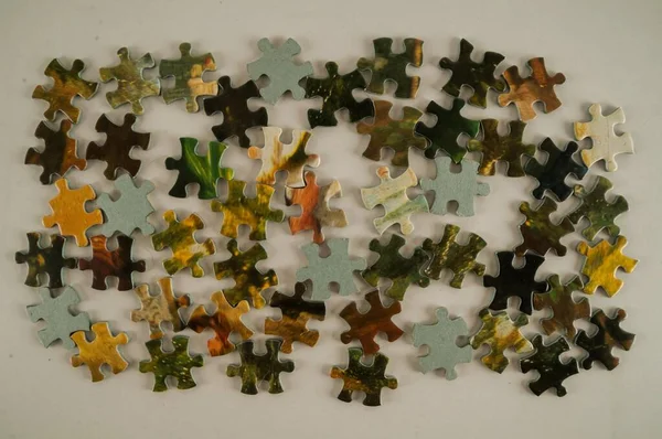 stock image puzzle pieces of different sizes and colors on a white background