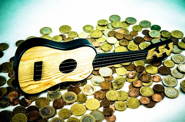Picture of a Business Money Concept Idea Coins and Guitar