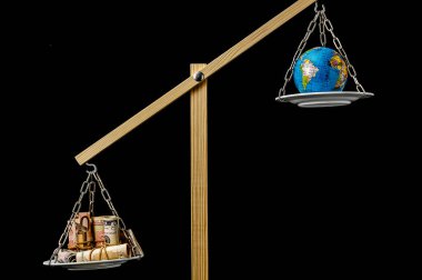 Globe Planet Earth and Money on a Two Pan Balance clipart