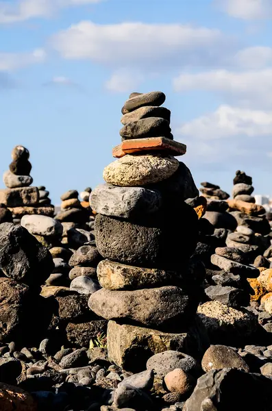 stock image A stack of rocks is piled on top of each other. The rocks are of different sizes and shapes, and they are arranged in a way that creates a sense of balance and stability