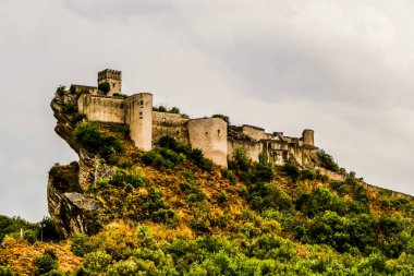 Ancient castle of Roccascalegna sited on a rocky headland clipart