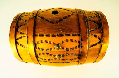 A wooden barrel with a gold design on it. The design is made up of small squares and circles clipart