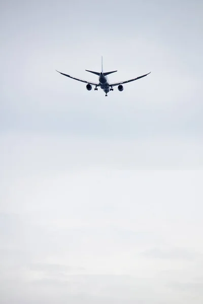 Passenger plane taking off in the dark cloudy sky