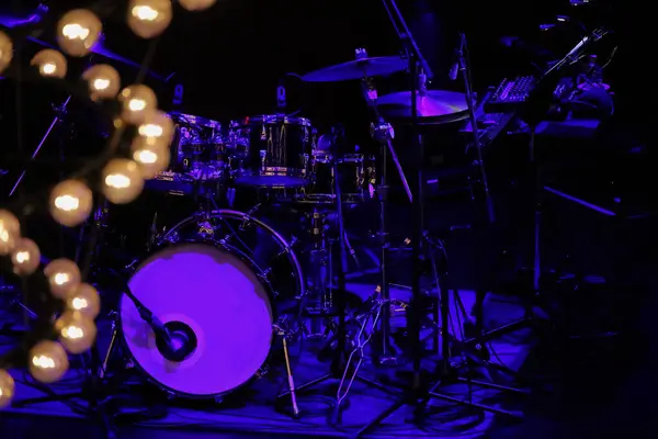 stock image A drum set on the stage of a dimly lit live music venue before the show begins