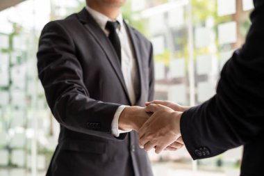 Ofis odasında iki işadamı el sıkışıyor. Tebrikler, selamlama ve anlaşma konsepti.