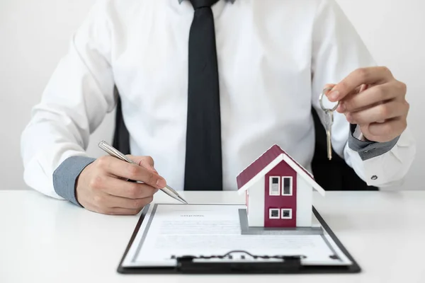 stock image Businessman working real estate and investment, checking a contract document of home loan insurance in the office.