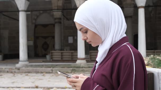 Muzułmańska Dziewczyna Sms Muzułmanka Patrząca Swój Telefon Dziedzińcu Meczetu Połączenie — Wideo stockowe
