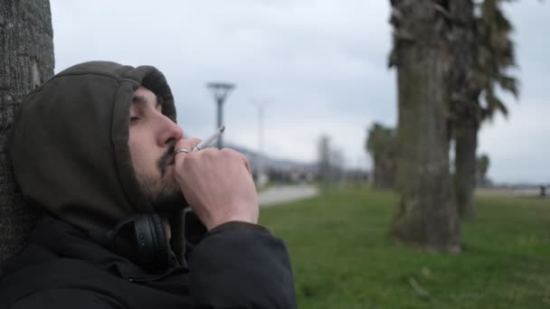 Lonely Man Smoking Thoughtfully Leaning Tree Park Depressed Teenager Thinking — Stock Video