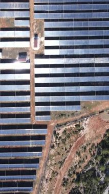 Aerial drone view of solar panels installed on mountain land, solar energy generation system installed in Turkey, energy system built with rows of glass blocks source of solar 