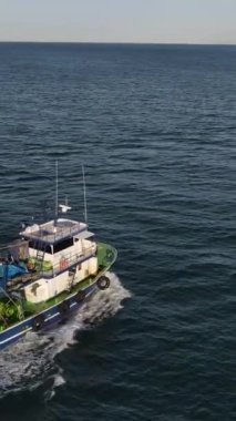 Drone view of boats advancing to fish in the sea, fishing boats on the lake, fishing season, hunting with seanets