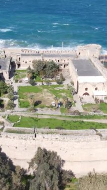 Inside the walls of the historical castle built by the sea, Kyrenia castle taken by drone from the air, Girne protected by the castle walls