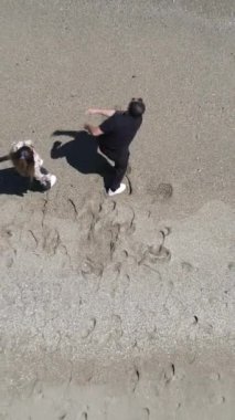 Havacı genç çift kumsalda birlikte vakit geçiriyor, sevimli çift denizde zıplayan taşlar oynayarak eğleniyor, sahilde sevgilisiyle aktiviteler yapıyor.