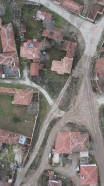 Aerial drone view of small village, small population tile roofed houses, rural life village houses roofs, settlement in rural village in autumn
