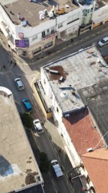 Aerial drone view of the streets of the city of Kyrenia and the layout of the buildings, the traffic flow on the street, the streets made up of apartment blocks in TRNC