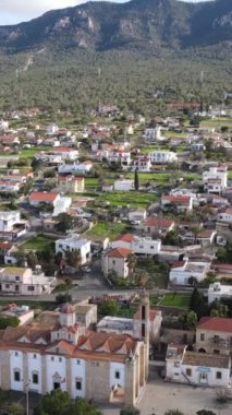 Aerial drone view of Esentepe, the city of Cyprus, layout of cities on the island, aerial view of buildings and streets, city with mountain and sea view