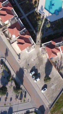 Drone view of the city settlement of cyprus, the layout of the apartments of the holiday city of girne, the swimming pool and the streets of the living area in the greenery