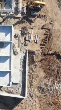 Drone view of building construction vehicles, drone view of hotel construction site, work of heavy-duty equipment