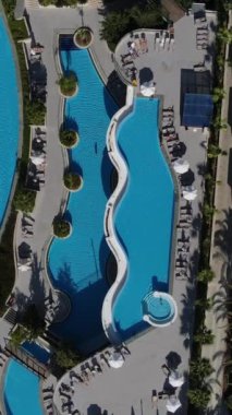 Lüks bir otel, lüks bir otelin havadan görünüşü, tatilciler havuzda yüzüyor ve güneşleniyor güzel havanın tadını çıkarıyor, Antalya, Türkiye