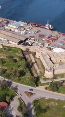 Drone view of the historical castle of the city of Kyrenia built against the harbor, the castle and the ship port by the sea, aerial views of the Kyrenia coastline