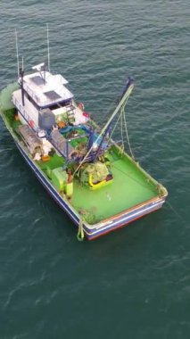 Drone view of boats advancing to fish in the sea, fishing boats on the lake, fishing season, hunting with seanets