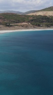 Drone view of volcanic lake Salda lake surrounded by mountains, tectonic lake famous for its white sandy beach and turquoise waters, magnificent beauty of nature lake salda
