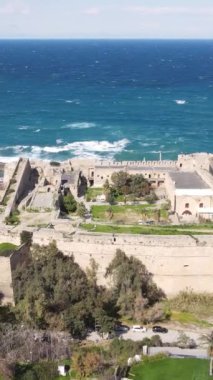 Drone view of the historical Kyrenia castle built by the sea, the walls of the historical castle made of stone, the historical beauties of the city of Kyrenia near the sea
