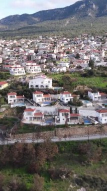 Aerial drone view of Esentepe, the city of Cyprus, layout of cities on the island, aerial view of buildings and streets, city with mountain and sea view