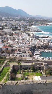 Inside the walls of the historical castle built by the sea, Kyrenia castle taken by drone from the air, Girne protected by the castle walls